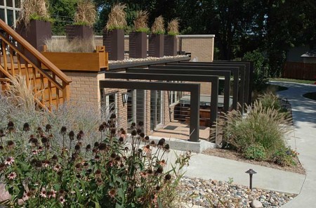 Johnston roof deck and outdoor patio Contemporary steel arbor is softened by tall grasses and landscaping.