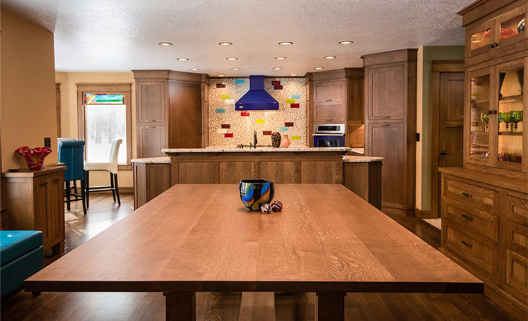 White oak craftsman-style dining table designed and built by Silent Rivers for the dining room and kitchen they remodeled in a West Des Moines home