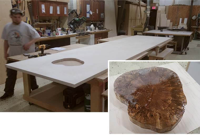 Alex Schlepphorst of Silent Rivers has made the precise cutout for the silver maple tree stump that will support the 16 foot island in a downtown Des Moines loft kitchen remodeled by Silent Rivers