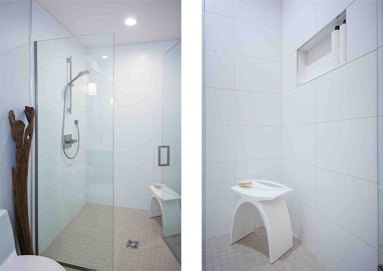 White tile curbless shower with glass enclosure in a modern bathroom remodel by Silent Rivers Des Moines features a modern shower bench