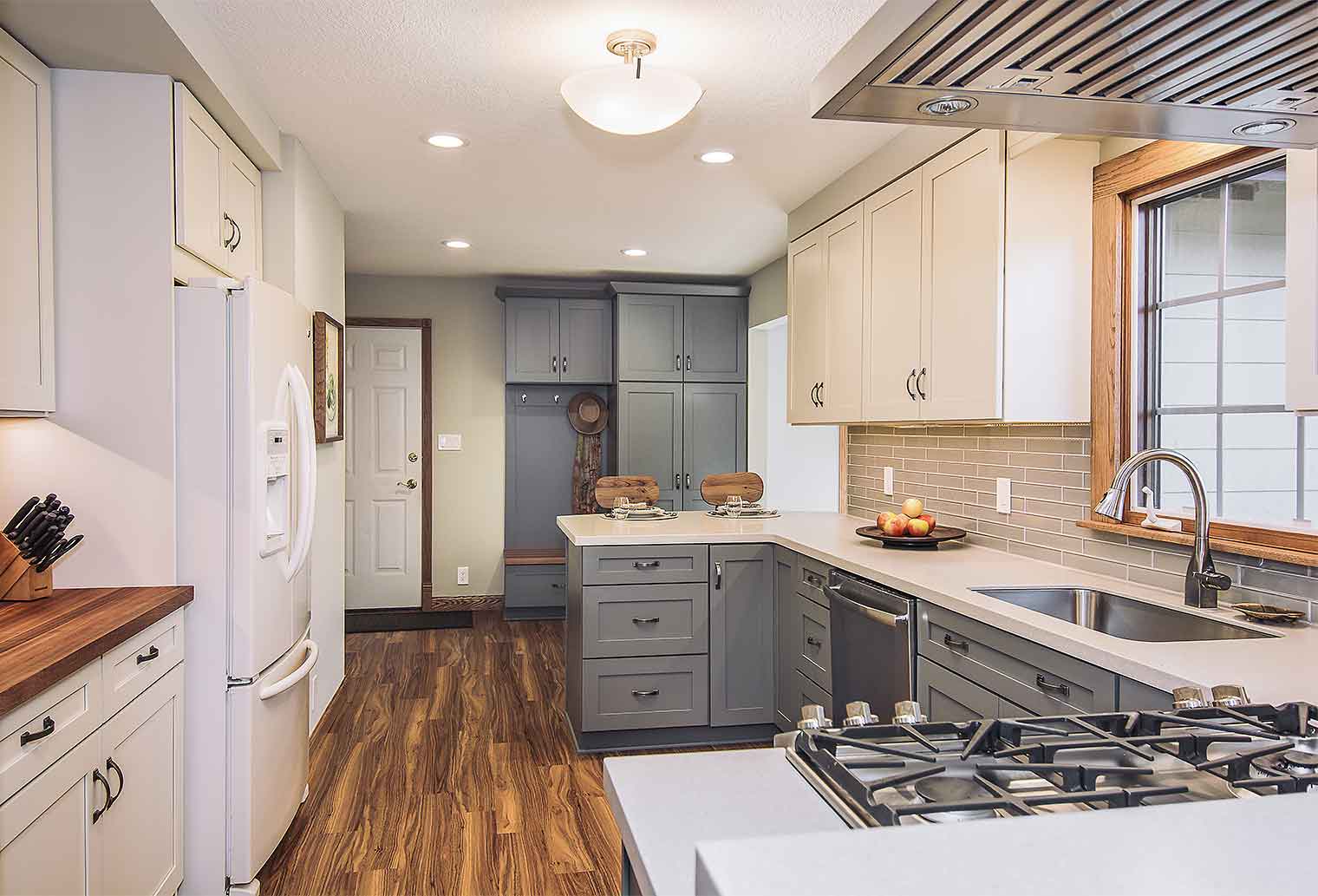 Transitional kitchen remodel with gray cabinets and luxury vinyl flooring and drop zone by remodeler Silent Rivers, Des Moines