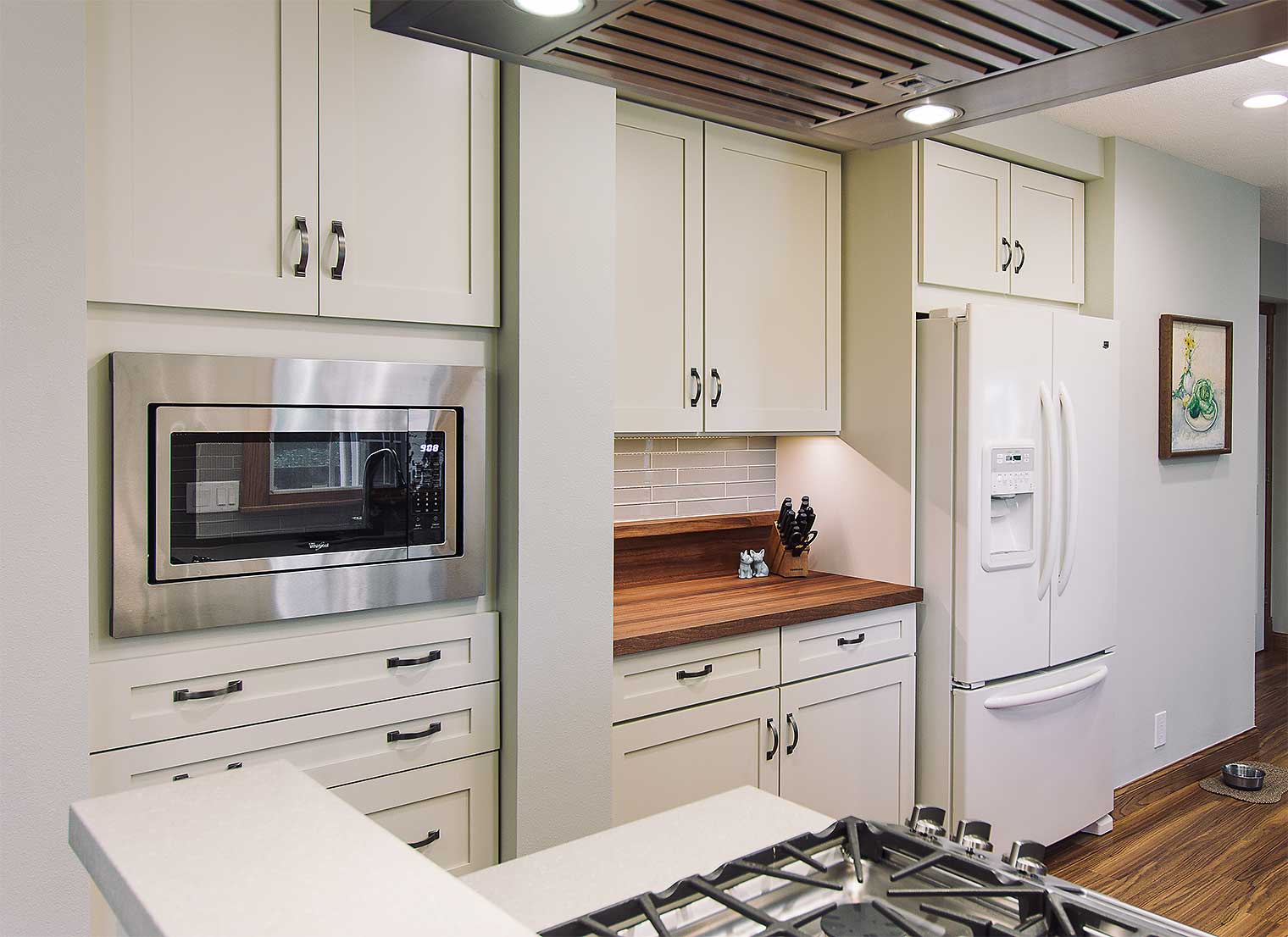 White refrigerator blends seamlessly with new cream cabinet in kitchen remodeler Silent Rivers Des Moines