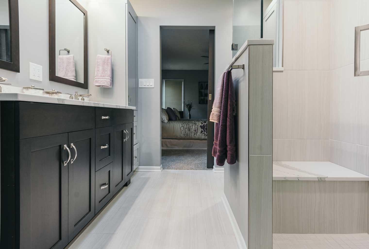 Zero entry shower custom double vanity in contemporary bathroom designed and built by remodeler Silent Rivers Design+Build, Des Moines, Iowa
