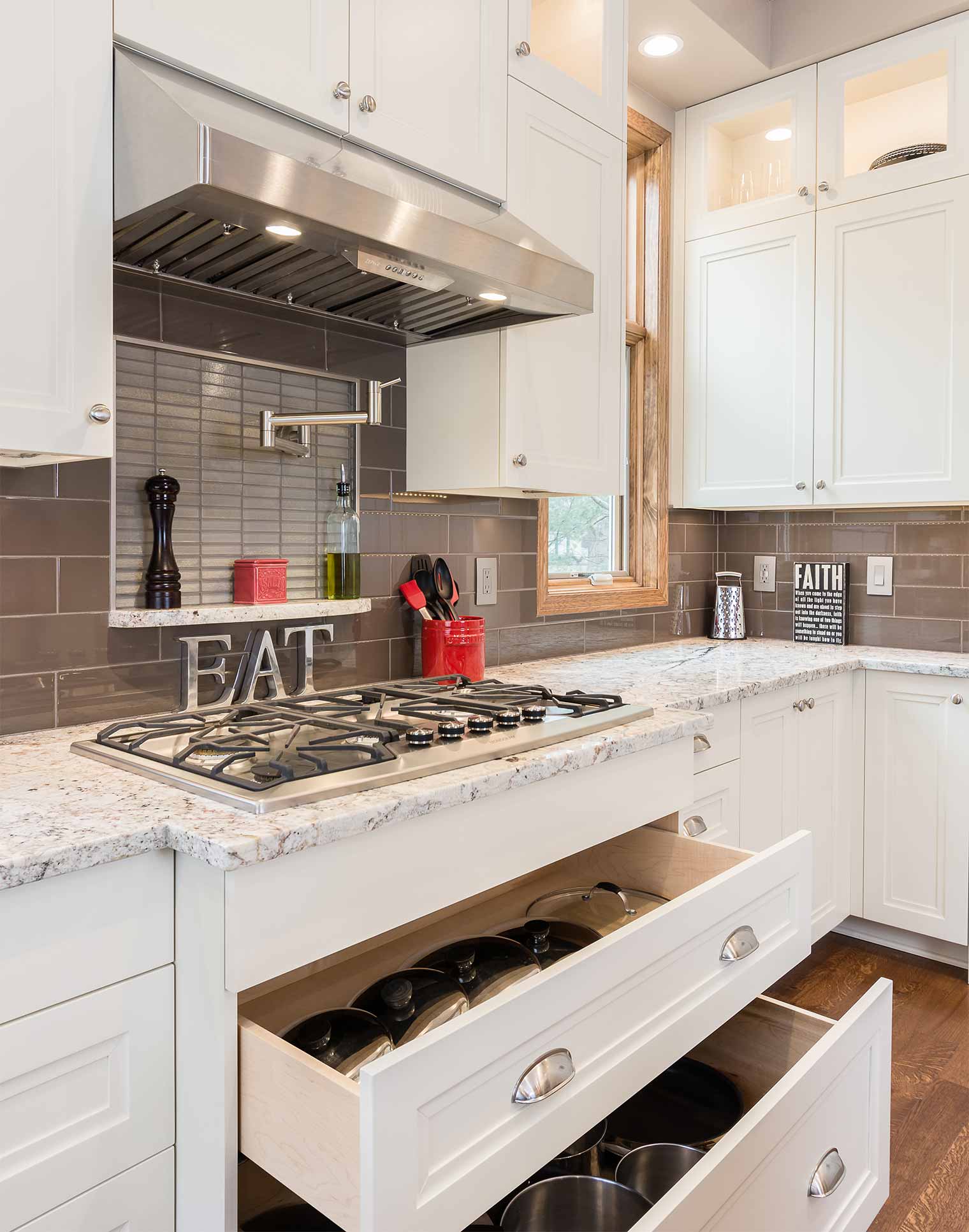 Large kitchen remodel designed and built by Silent Rivers in Clive, Iowa features large drawers under range