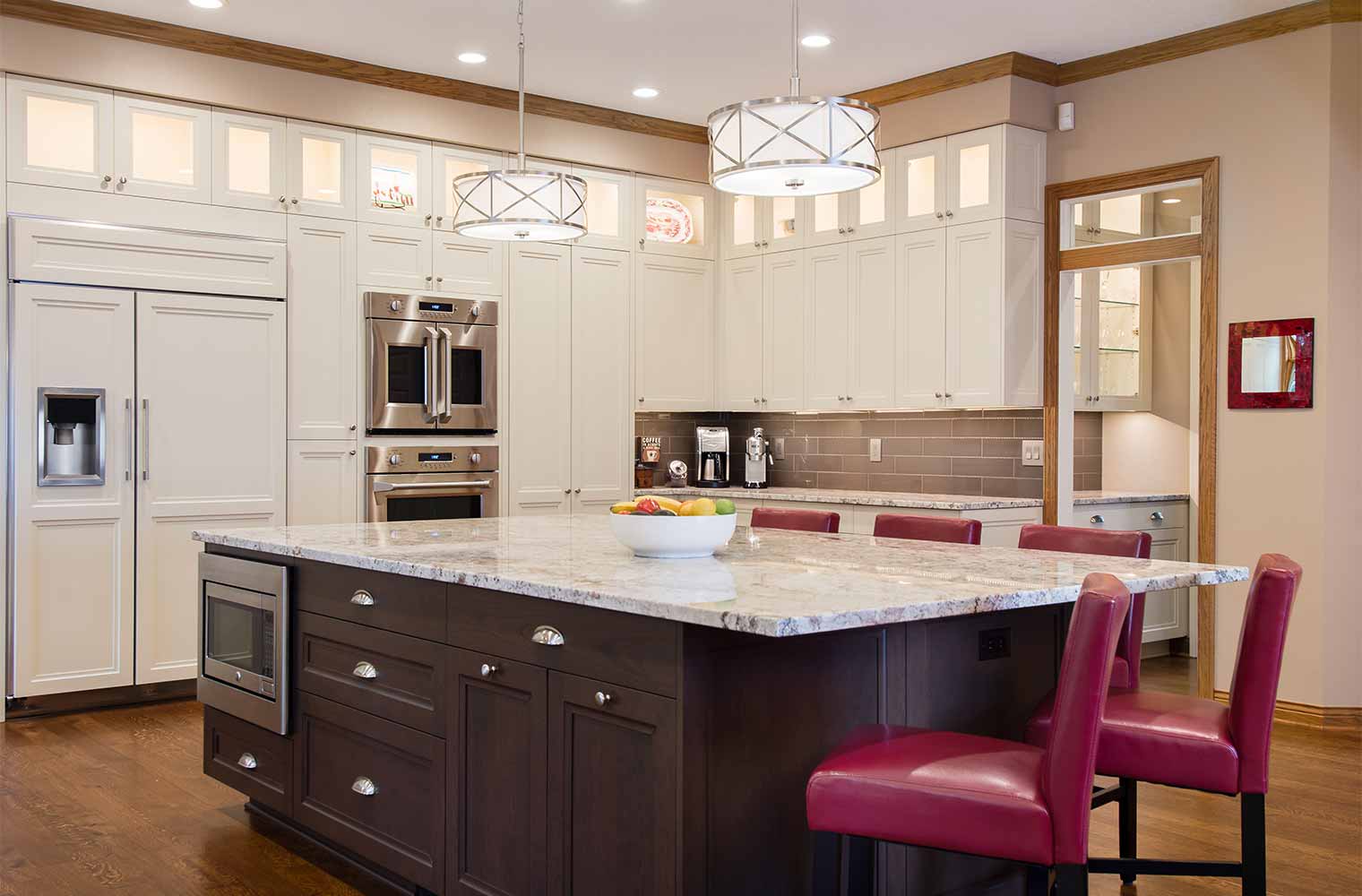 Large kitchen remodel designed and built by Silent Rivers in Clive, Iowa features large island with microwave built in