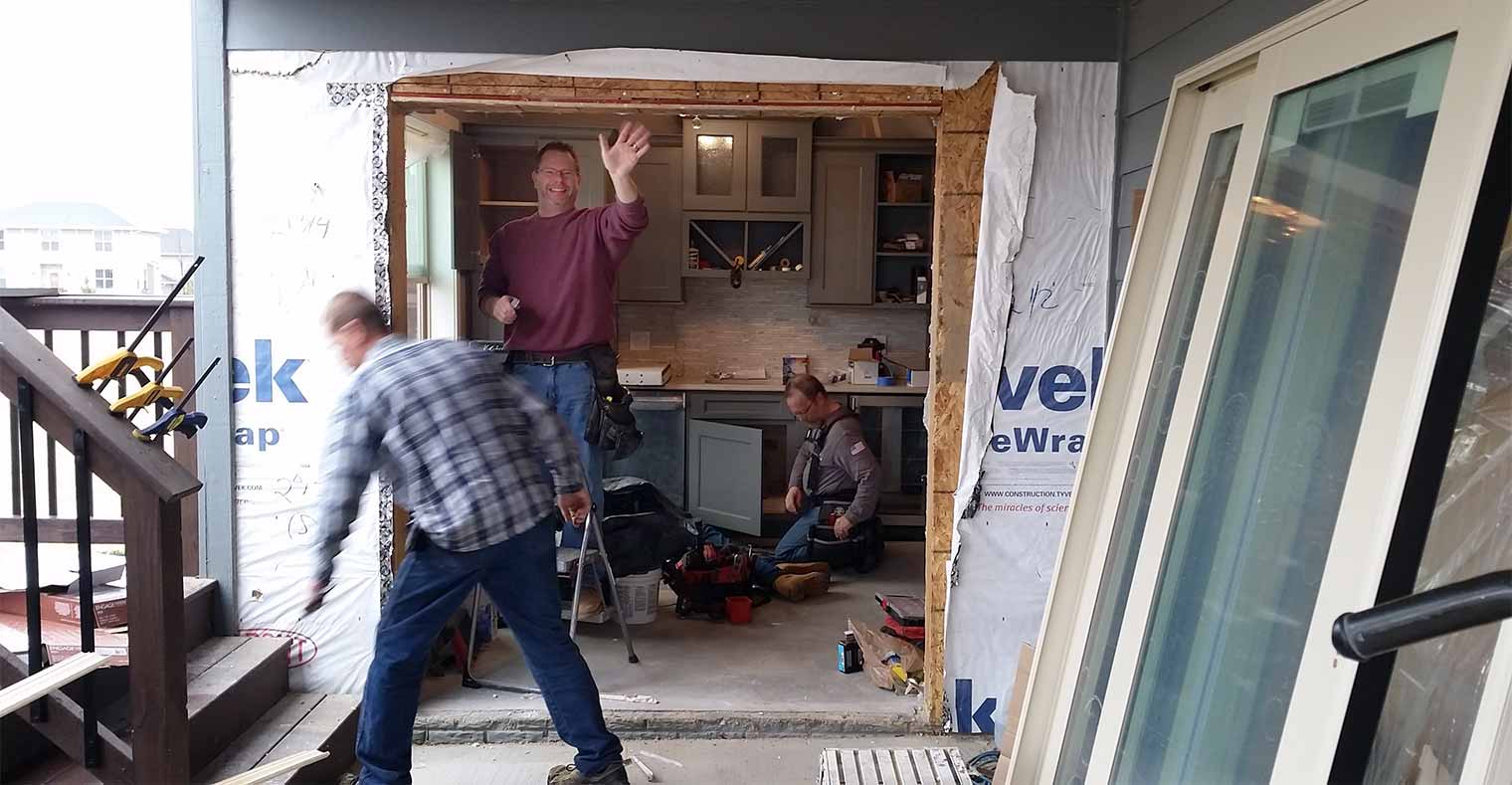 John Miller of Silent Rivers helps install new patio doors on an Urbandale, Iowa home being remodeled by Silent Rivers