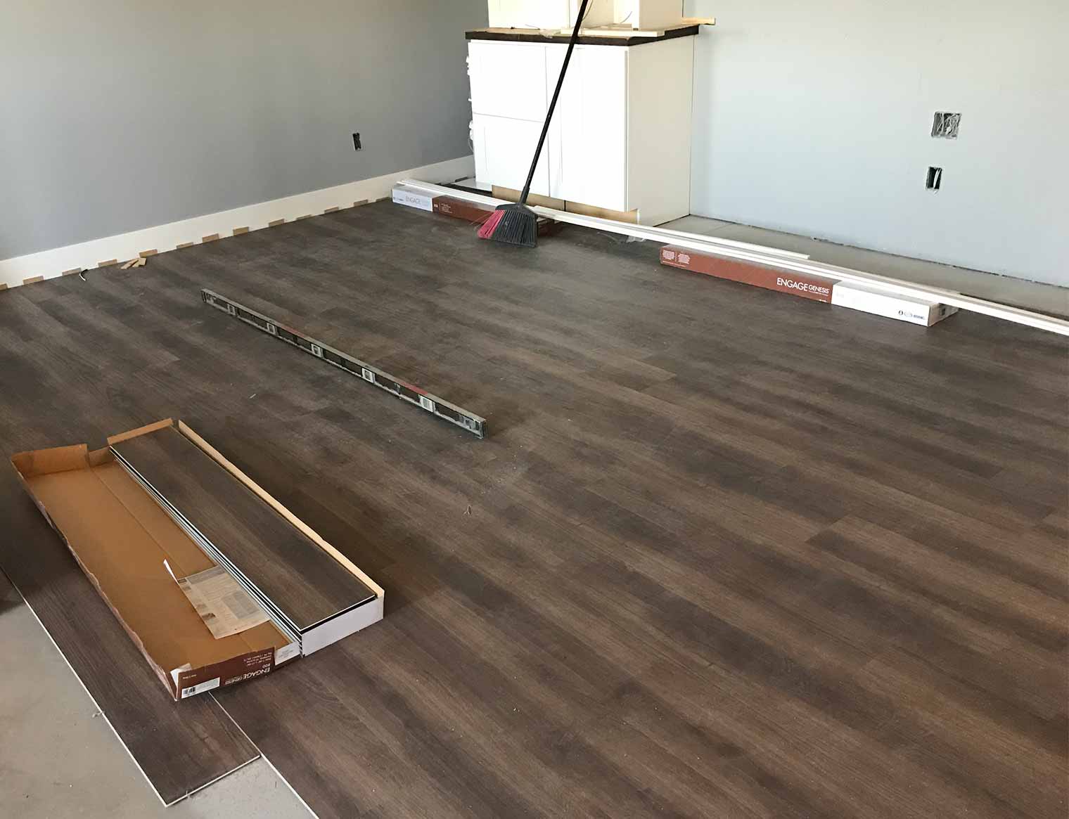 luxury vinyl tile being installed in Urbandale, Iowa basement remodel by Silent Rivers