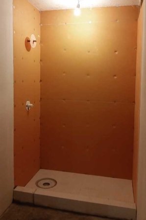 waterproof backing being installed in shower in Urbandale, Iowa basement remodel by Silent Rivers
