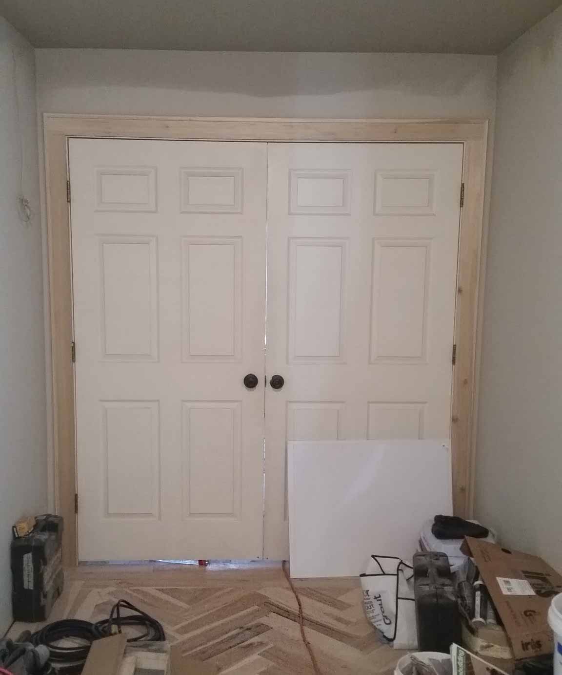 New french door casing and herringbone flooring are installed in a master suite remodel in Granger, Iowa designed and built by Silent Rivers