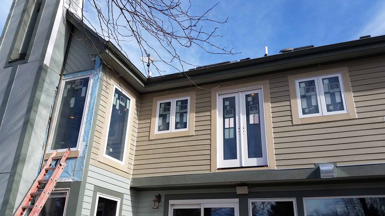 New windows and French balcony doors are installed for a master suite remodel in Granger, Iowa designed and built by Silent Rivers