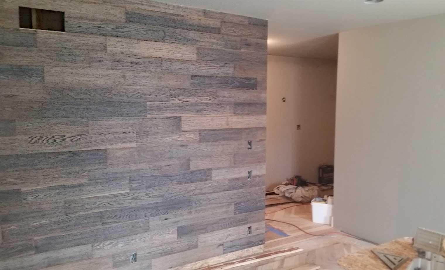 Wood clad accent wall is installed in a master suite remodel in Granger, Iowa designed and built by Silent Rivers