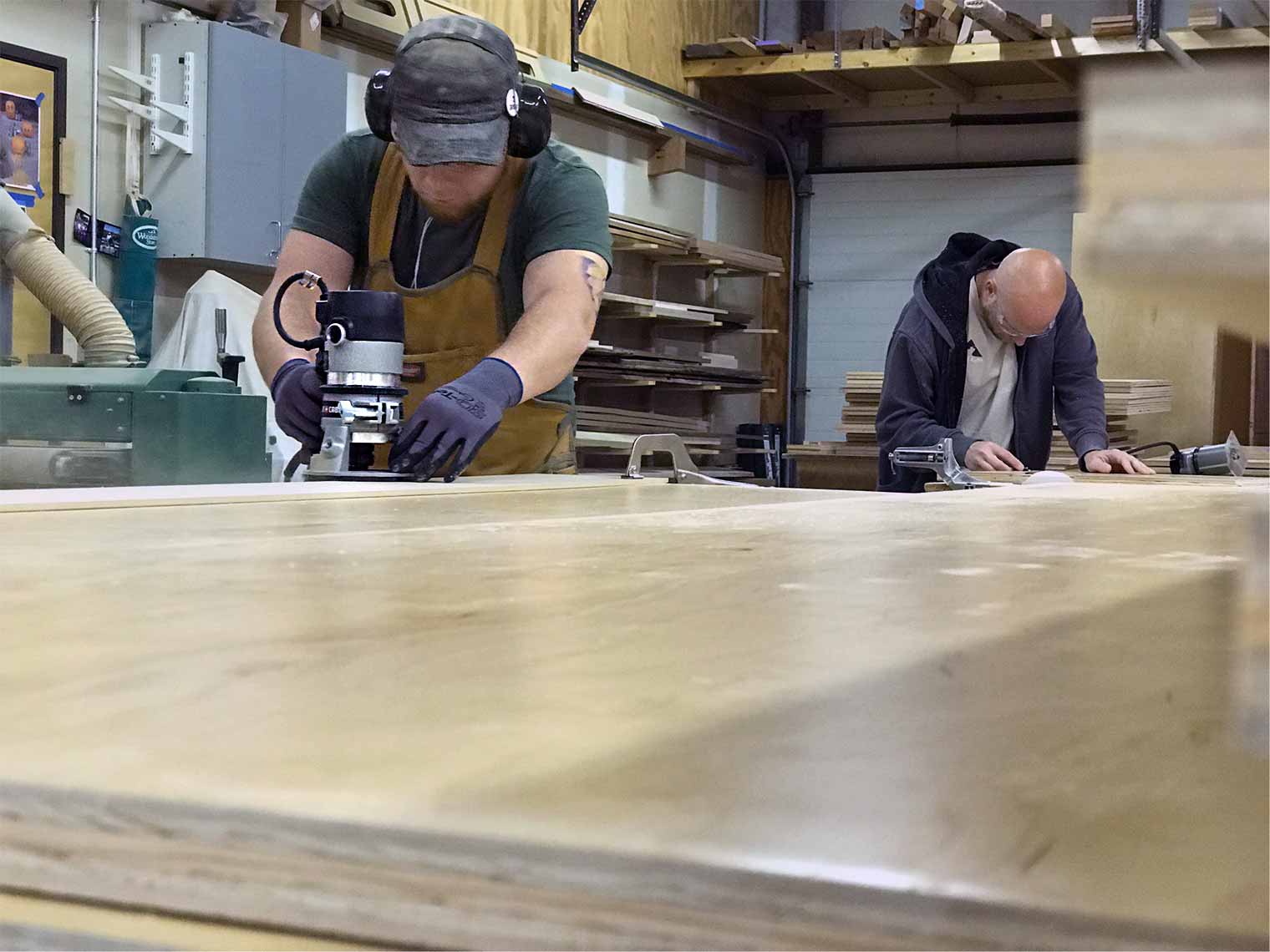 Alex Schlepphorst and Jon Curry work on custom cabinets being made in the Silent Rivers Woodshed