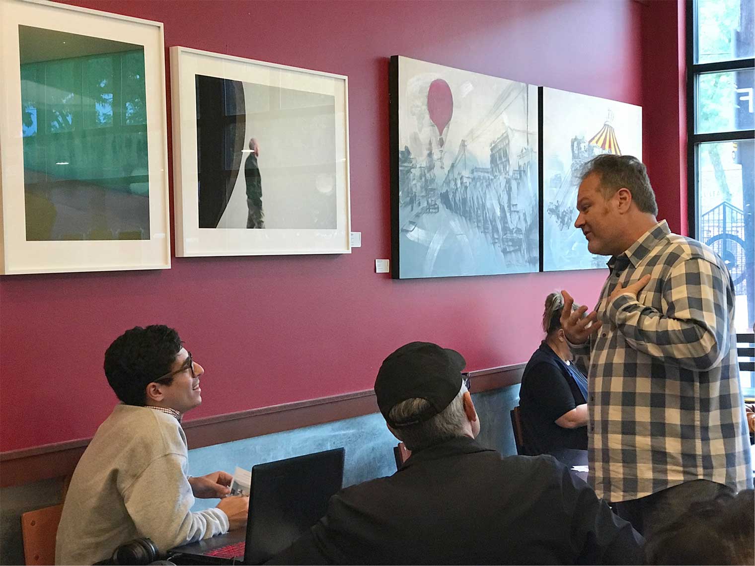 Silent Rivers’ Chaden Halfhill interacts with attendees at the “Recalling Place” gallery opening event on May 19.