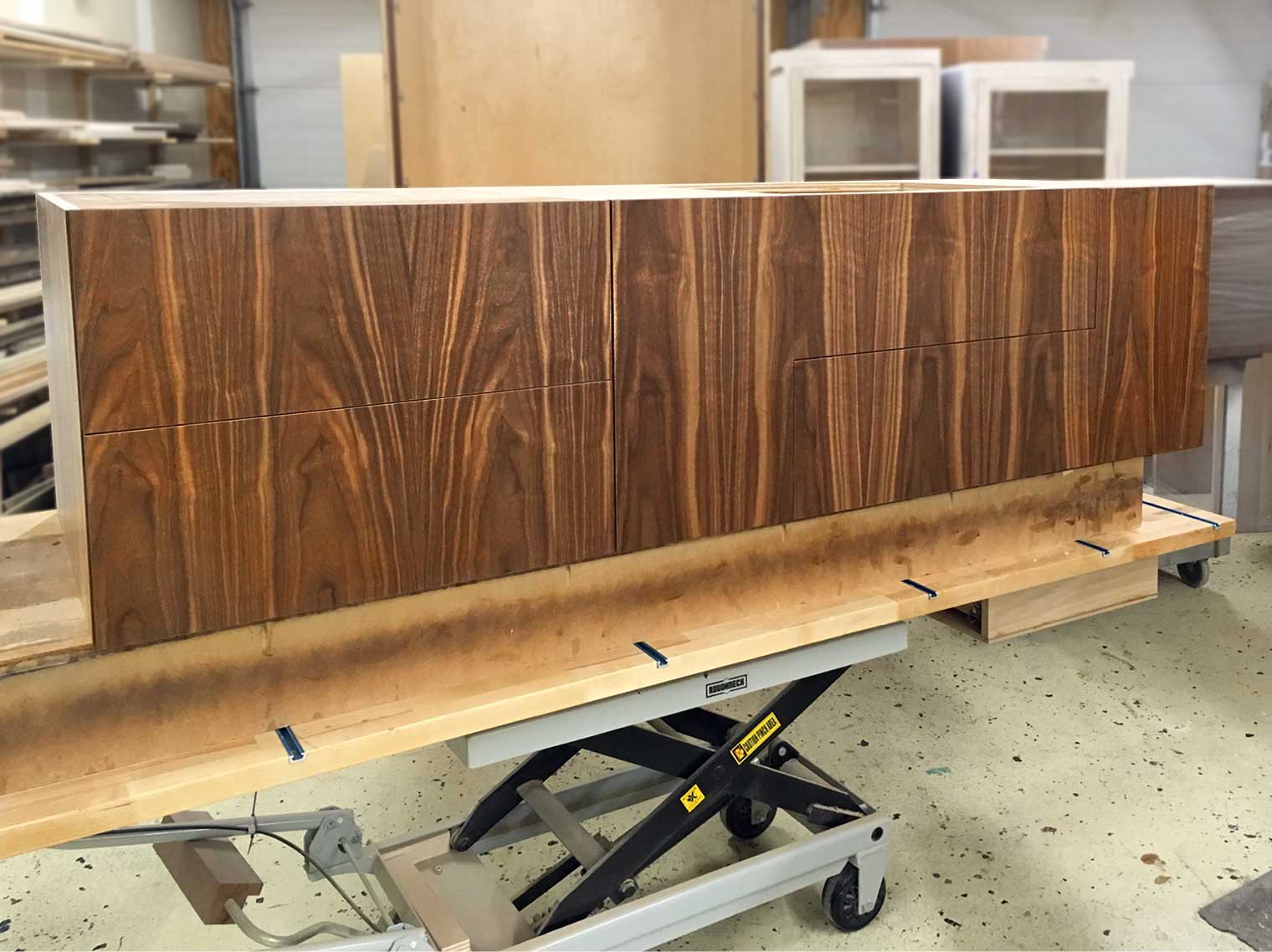 flat sawn walnut bathroom vanity custom cabinet created in the Silent Rivers woodshop waits to be delivered to client's home in Des Moines