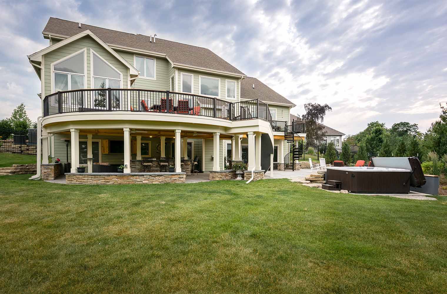 Backyard renovation_Backyard view of deck, patio and spa outdoor entertaining area on Urbandale home , designed and built by remodeler and new home builder Silent Rivers of Des Moines, Iowa
