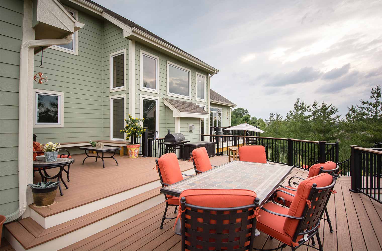 Backyard renovation_Upper deck with step down on an Urbandale curved deck, designed and built by remodeler and new home builder Silent Rivers of Des Moines, Iowa