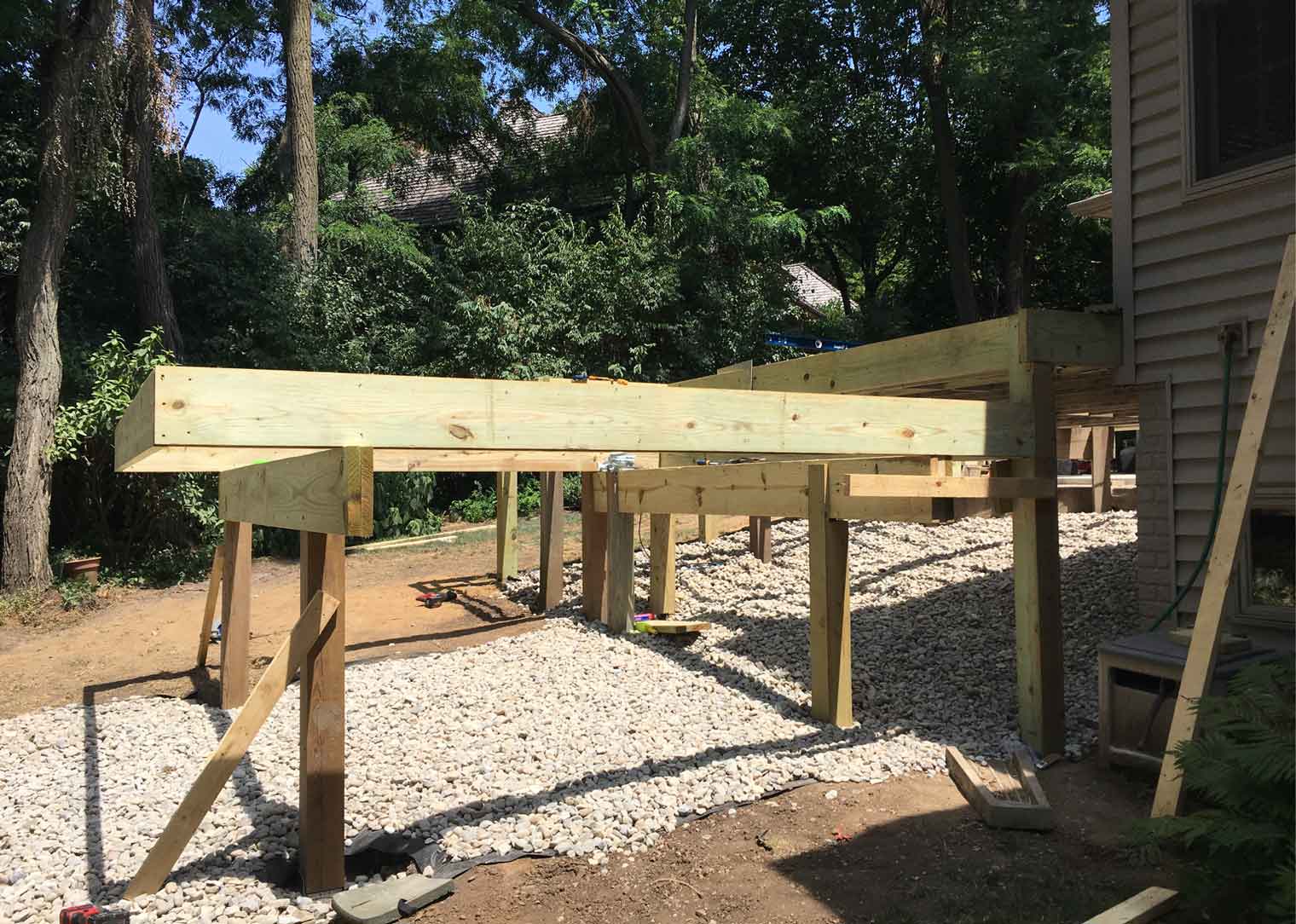 New deck in progress has a terrace over sloped backyard by deck builder Silent Rivers of Des Moines, Iowa