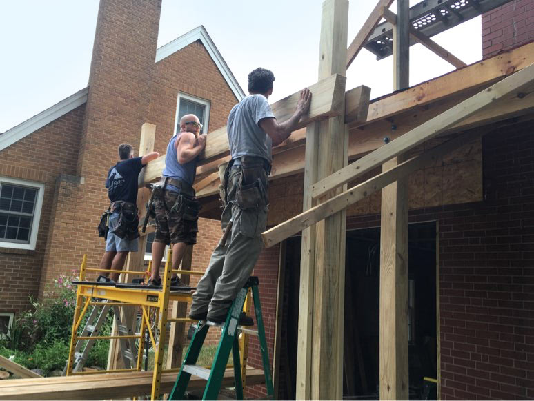 Silent Rivers crew installs framing for new carport on 1935 Des Moines Federal style home they are remodeling