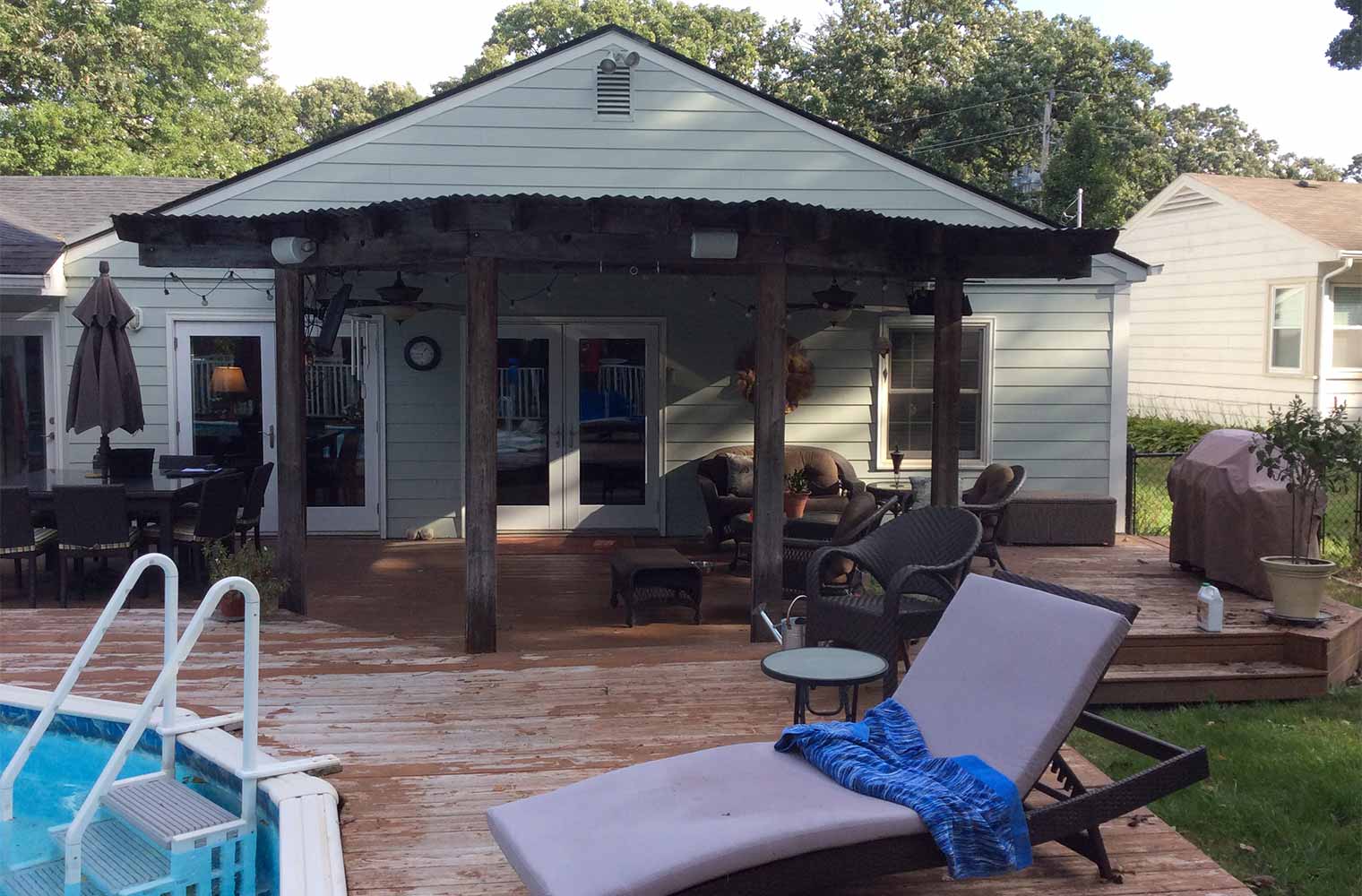 before photo of midcentury ranch home in Des Moines with pool deck in need of repair