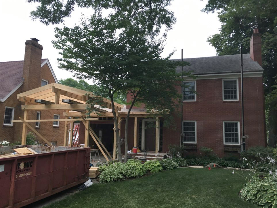 in progress photo showing framed new carport on 1935 Des Moines Federal style home by remodeler Silent Rivers