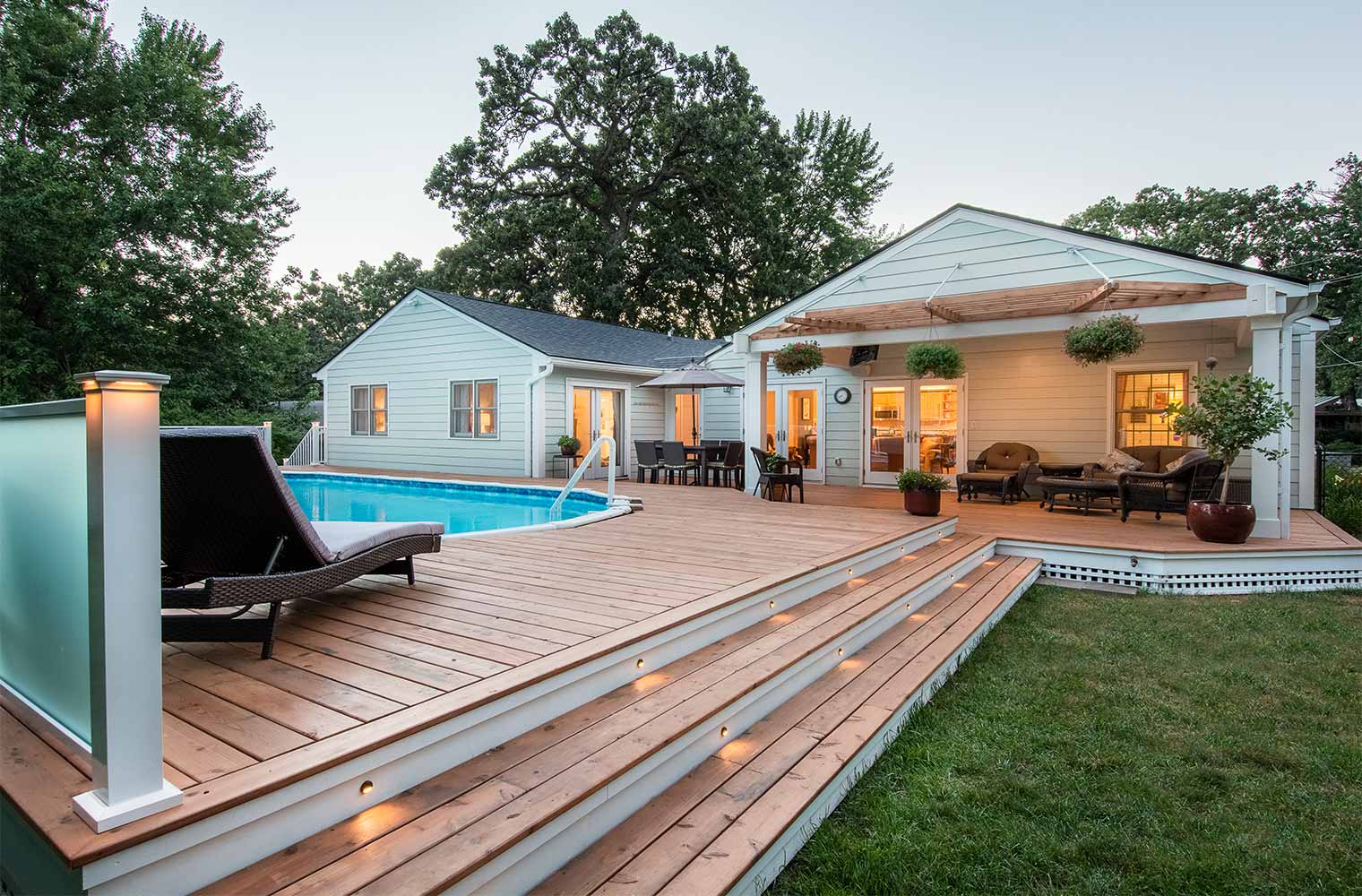 stairs leading to pool deck and outdoor entertaining area of midcentury ranch home in Des Moines, Iowa by remodeler Silent Rivers
