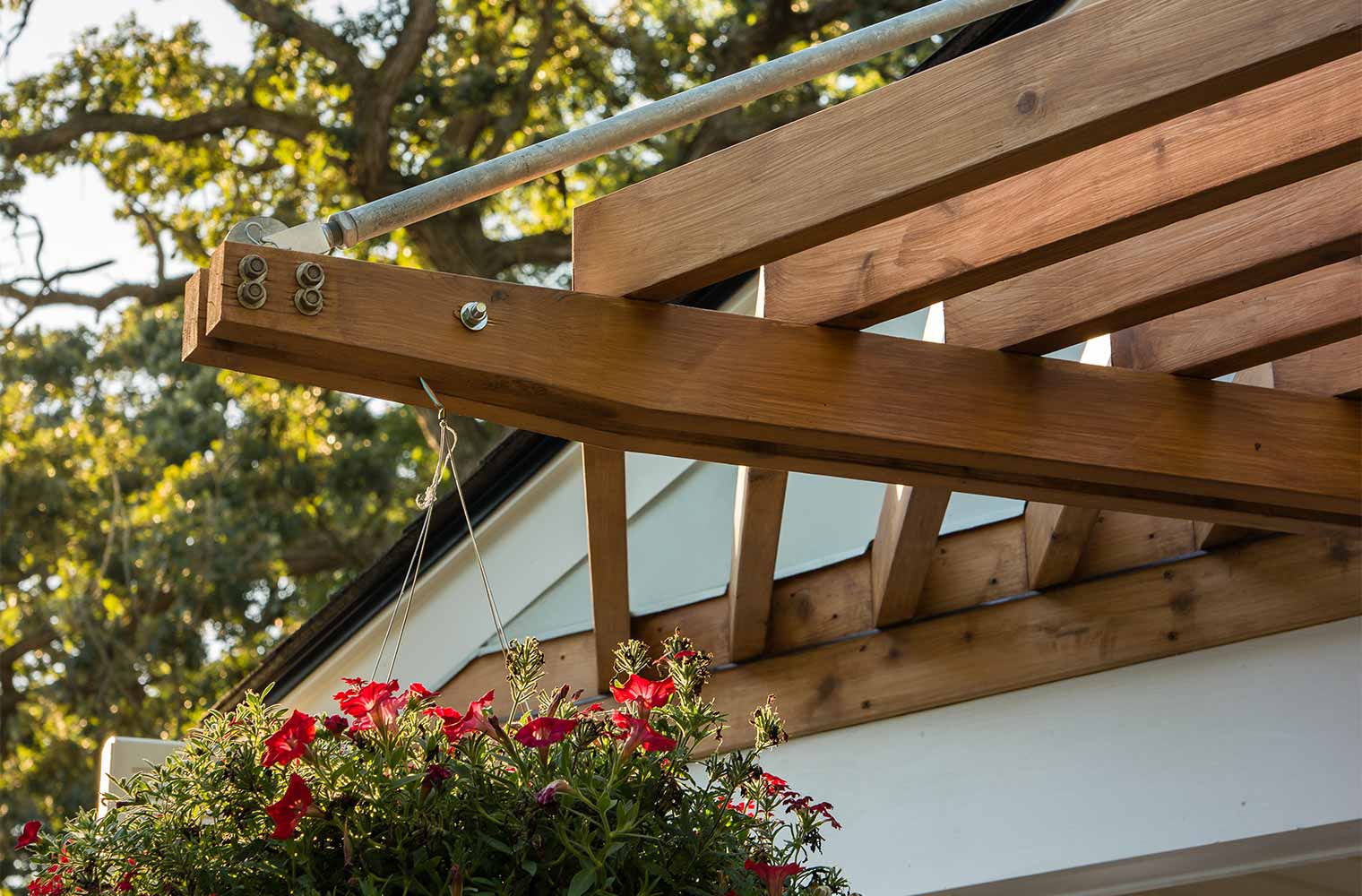 pergola suspended from midcentury ranch home in Des Moines, Iowa by remodeler Silent Rivers