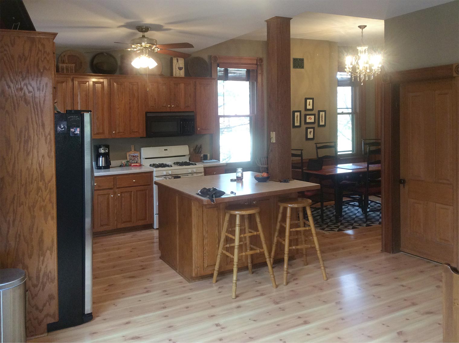 before photo of kitchen in a Des Moines Victorian home shows a column that visually divides the space