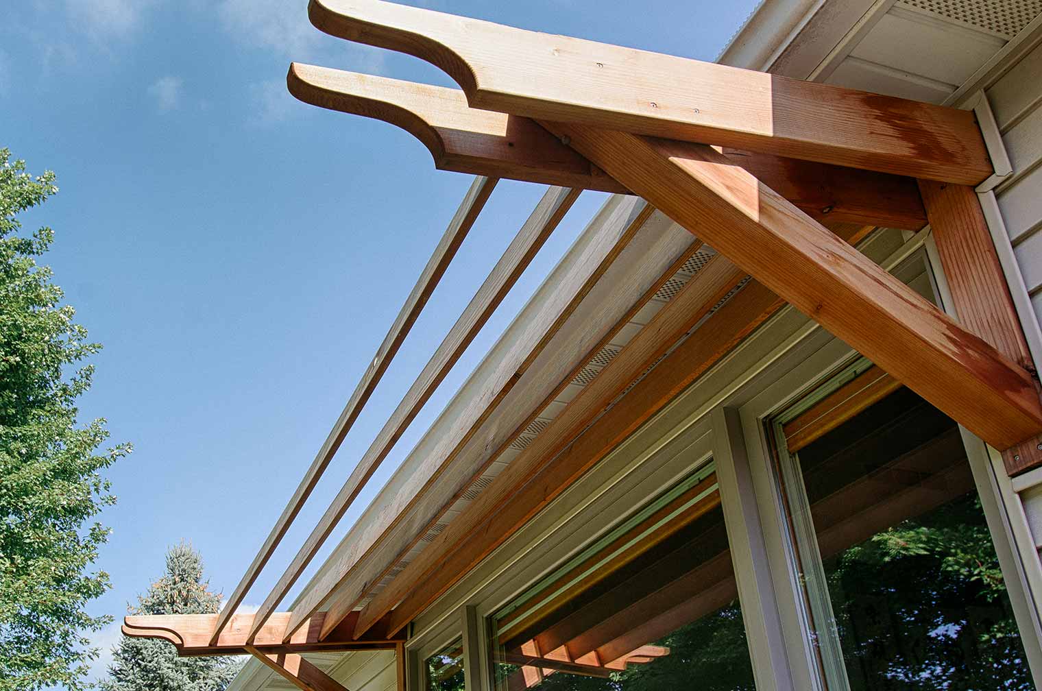 Asian style wood window awning on Ames home exterior remodel by Silent Rivers of Des Moines