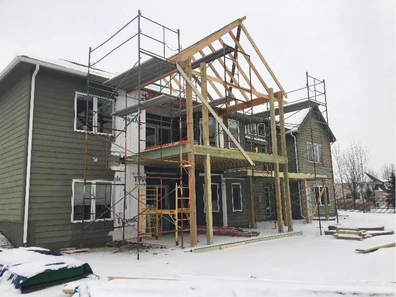deck and vaulted roof framing in progress for backyard retreat by Silent Rivers for a suburban Des Moines home