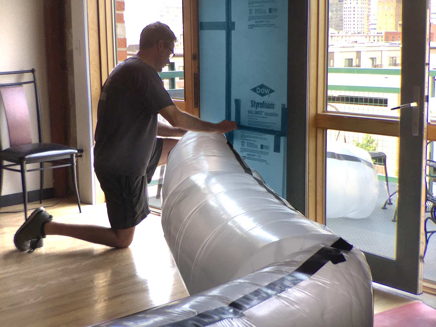 Christian Anderson of Silent Rivers Design+Build of Des Moines protects a home during remodel by installing an air tube for remodeling dust control and maintaining air quality