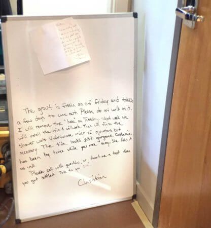 onsite message board for Silent Rivers to communication to homeowners during remodeling in a downtown Des Moines loft bathroom remodel